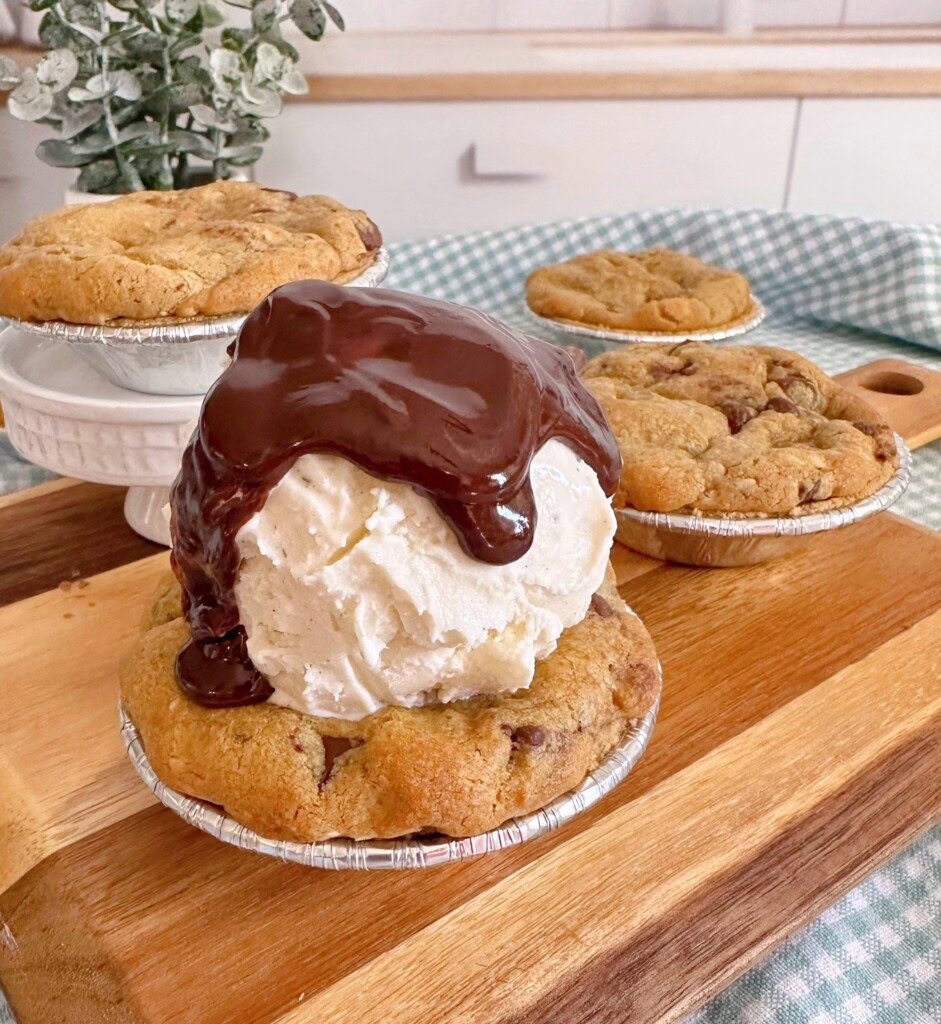 Mini S'mores Chocolate Chip Cookie Pies topped with Vanilla ice cream and homemade hot fudge sauce.
