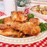 Oven fried chicken pulled out of the oven and placed on a serving platter.