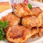 Oven Fried Chicken piled on a white serving platter .