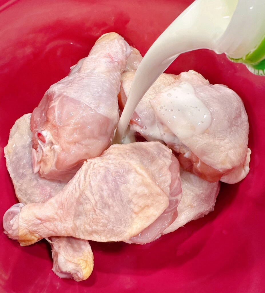 Soaking the chicken in a buttermilk bath.