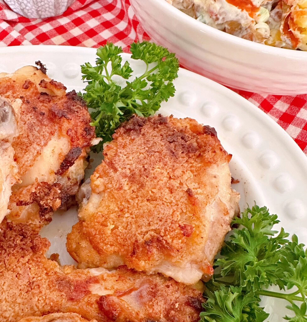 Up close photo of crispy piece of chicken on serving platter.