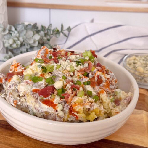 Smashed Crispy Buffalo Potato Salad in a bowl.