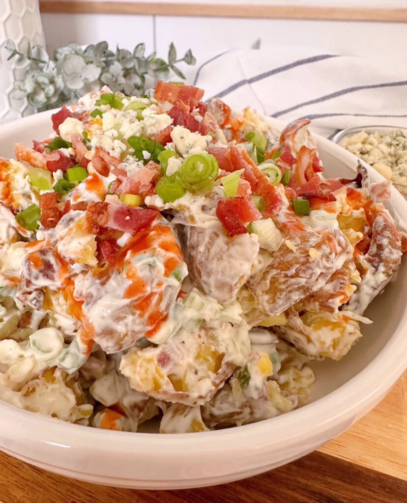 Smashed Buffalo Potato Salad up close with all the garnishes.