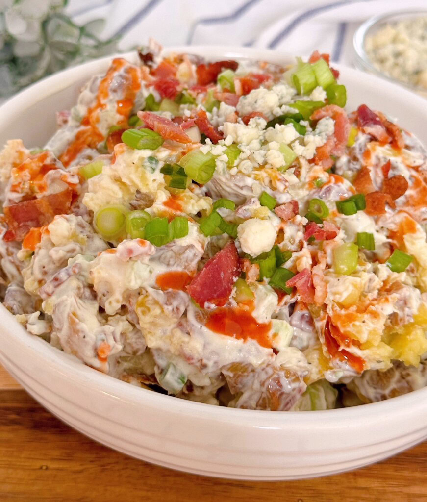 Buffalo blue cheese potato salad up close with buffalo sauce drizzle.