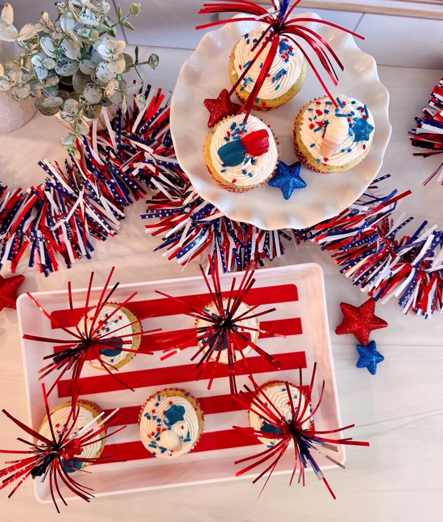 Cupcakes on a patriotic platter with fun cake pokes.