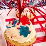 Single cupcake with frosting, sprinkles, and a cake poke decoration.
