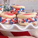 Stack of ice cream sandwiches on a pretty white serving dish.