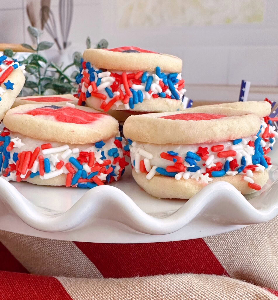 Stack of ice cream sandwiches on a pretty white serving dish.