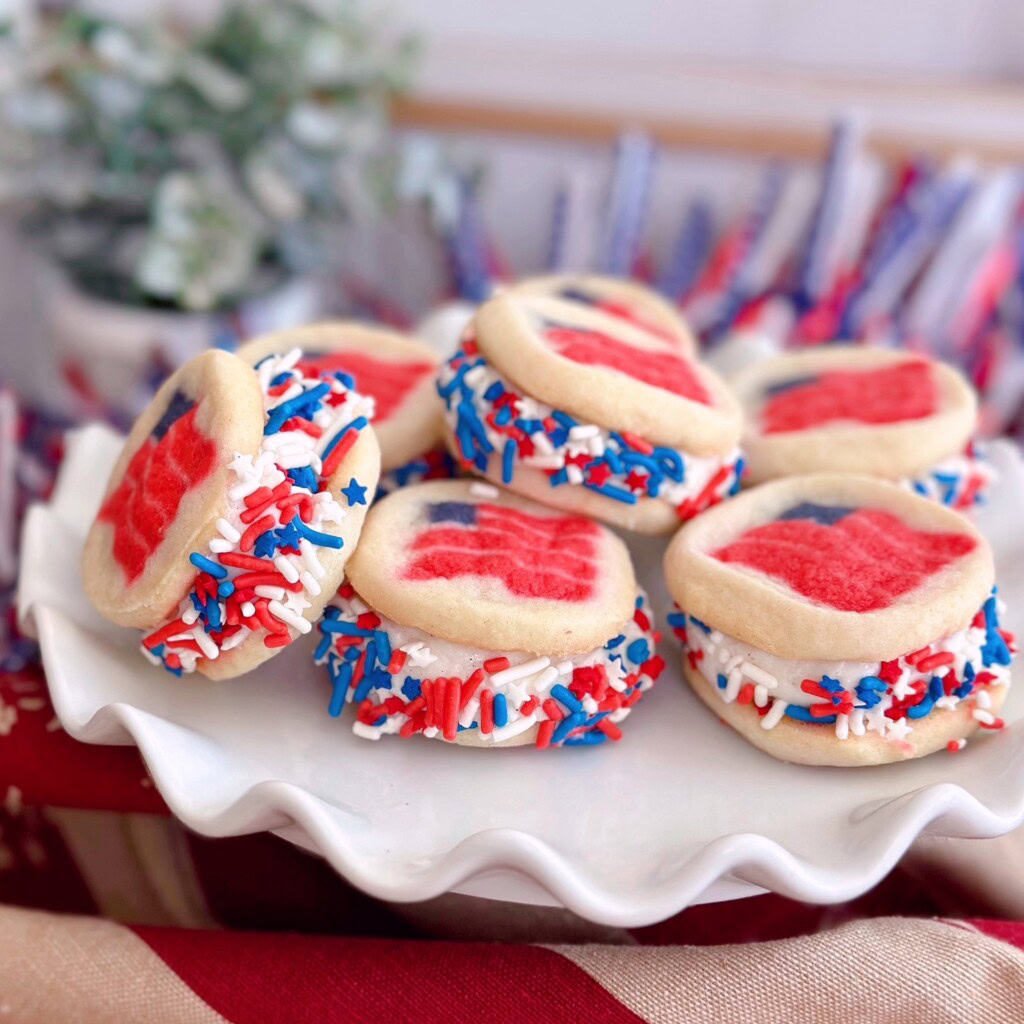 4th of July Pillsbury Sugar Cookie Ice Cream Sandwiches piled high on a white serving plate.