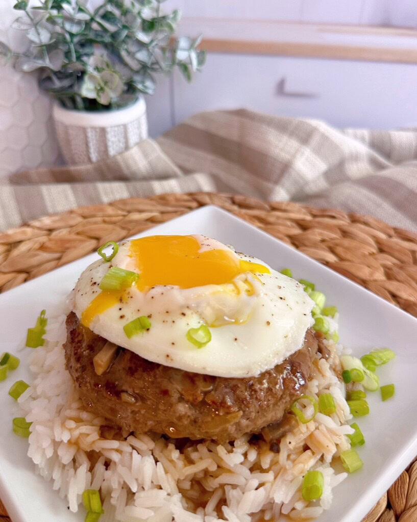 Egg topped Loco Moco with gravy and rice.