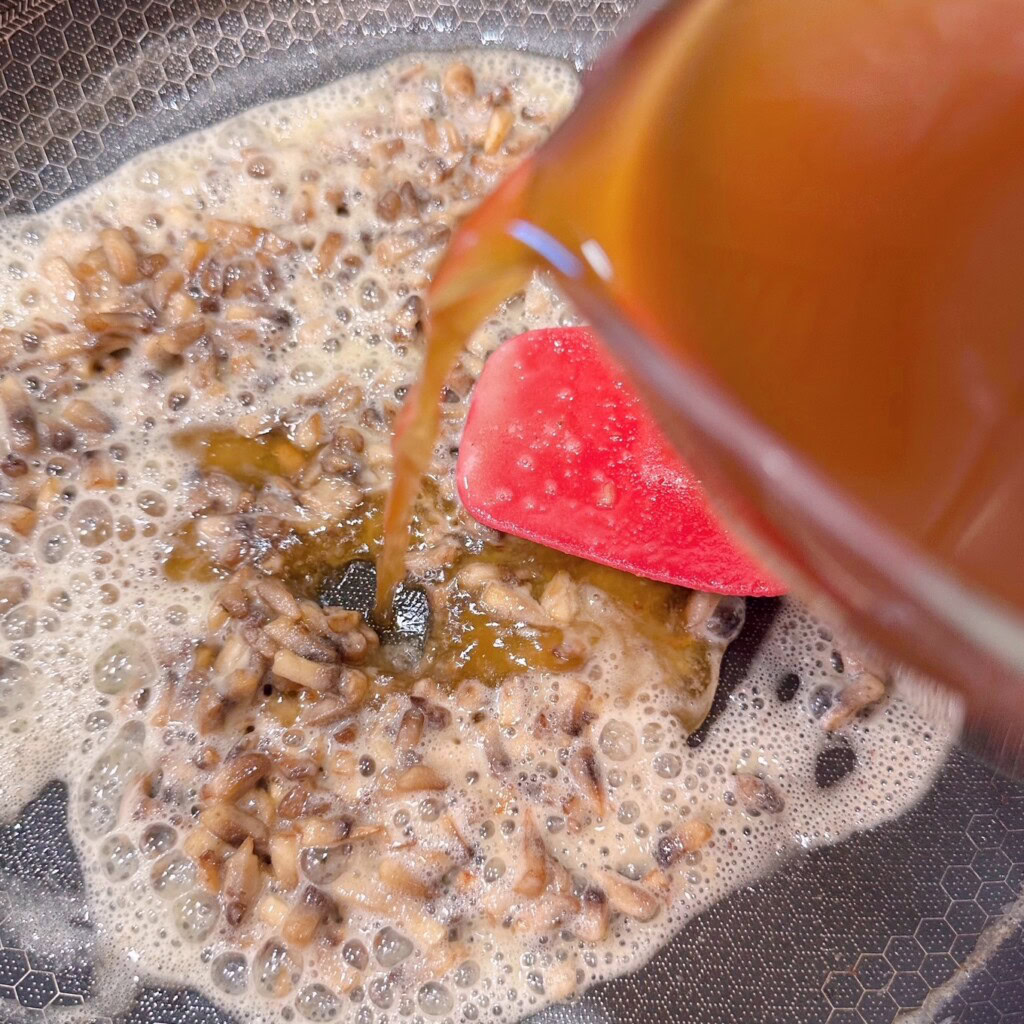 Adding beef broth to mushroom mixture.