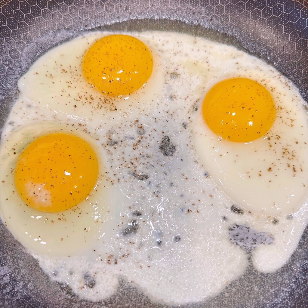 Cooking eggs in a large skillet.