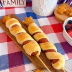 Two Stars and Stripes hot dog skewers on a mini cutting board.