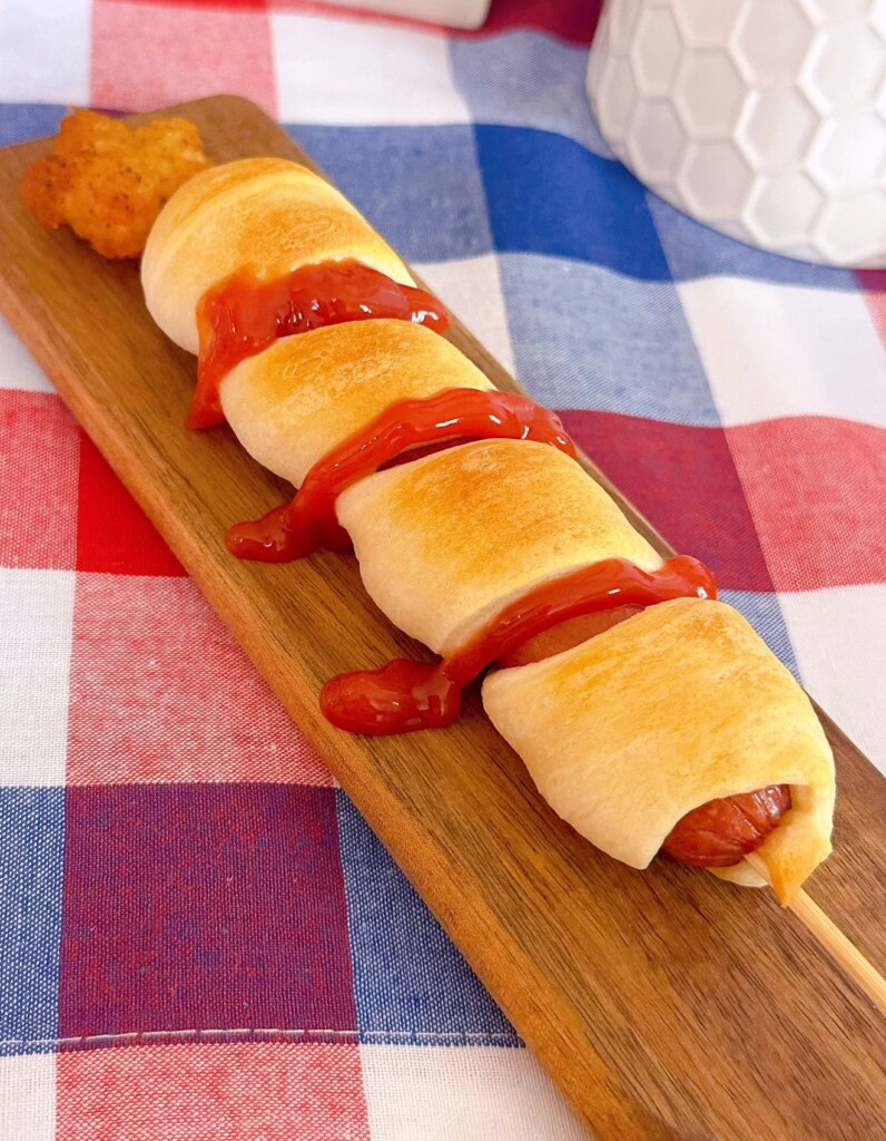 Hot dog with ketchup stripes.
