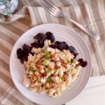 A serving of Chicken Bacon Ranch Pasta Salad on a plate with red leaf lettuce and a fork.