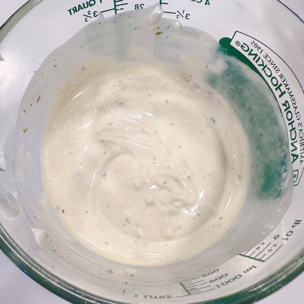 Salad dressing for Pasta salad mixed in a large measuring cup.