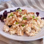 Chicken Bacon Ranch Pasta Salad serving on a plate with red leaf lettuce.