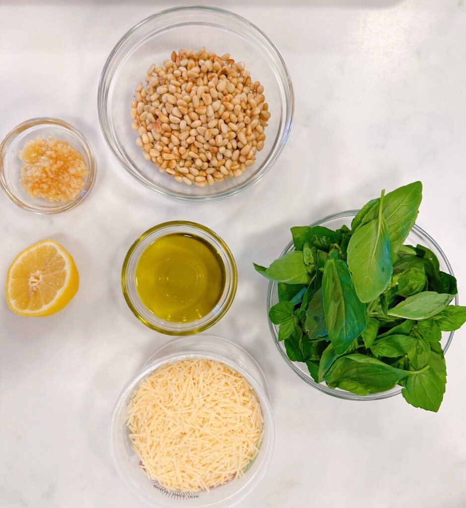 Ingredients for fresh basil pesto on a counter top.