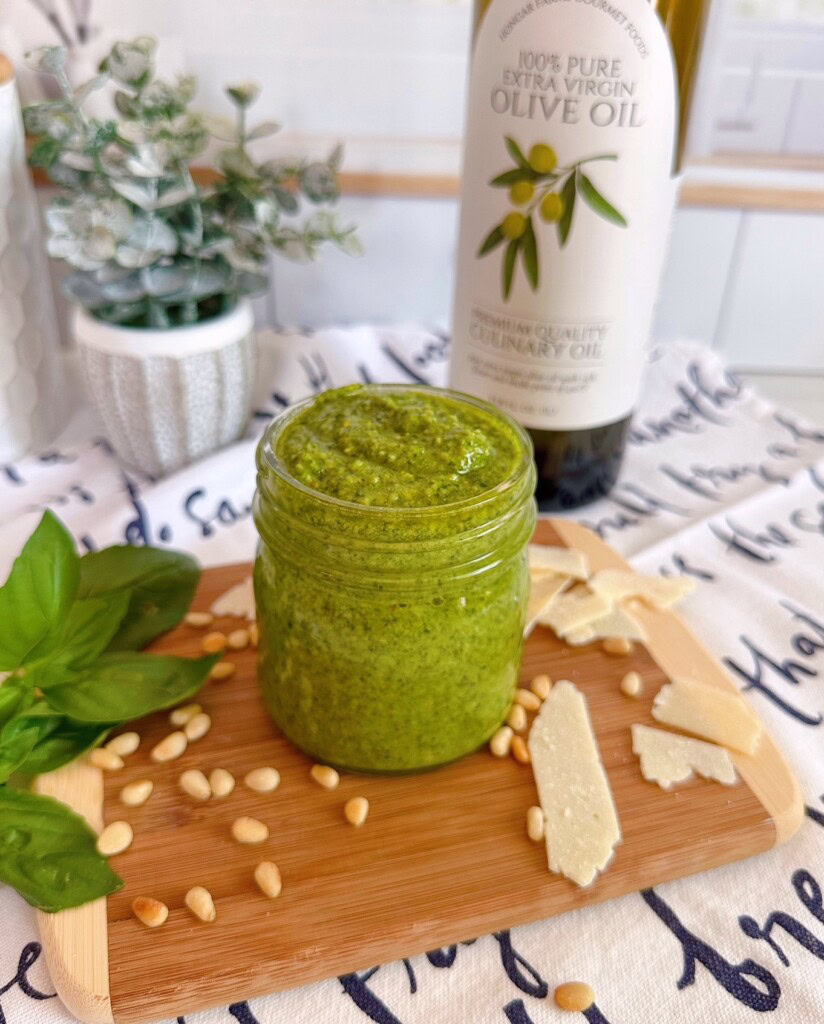 Pesto in a jar on a board.