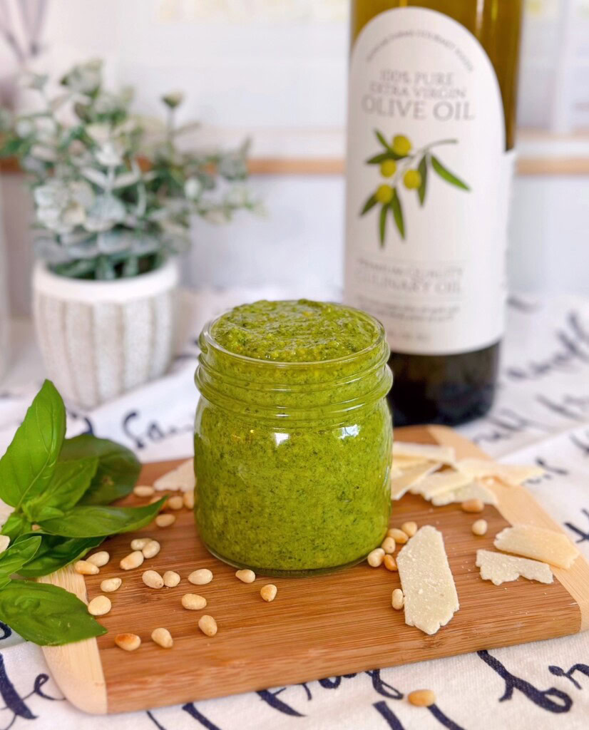 Fresh Pesto on a cutting board with fresh cheese and pine nuts.