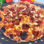 Pizza on a pizza wheel after baking.