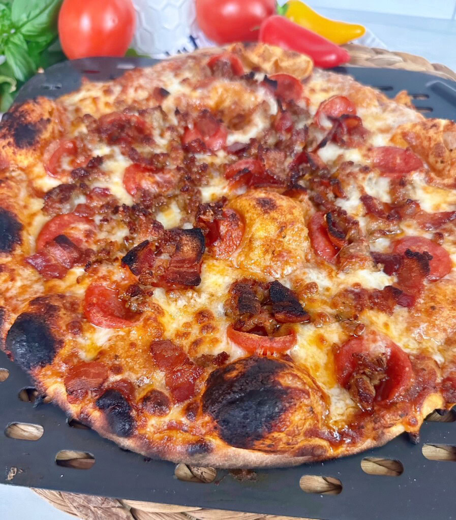 Pizza on a pizza wheel after baking.
