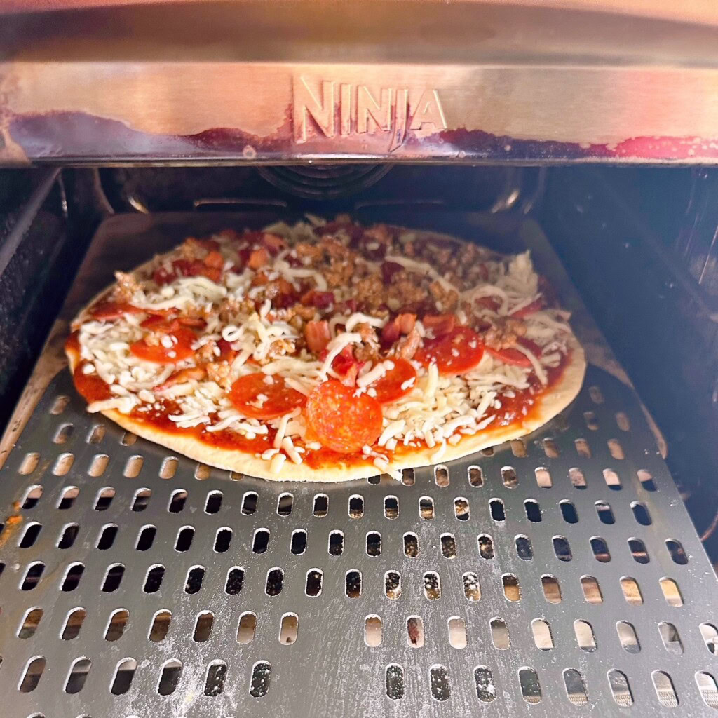 Pizza baking in the Ninja Pizza Oven.