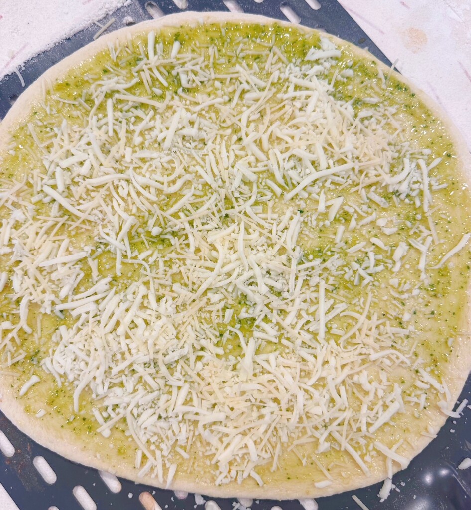Pizza topped with cheese.