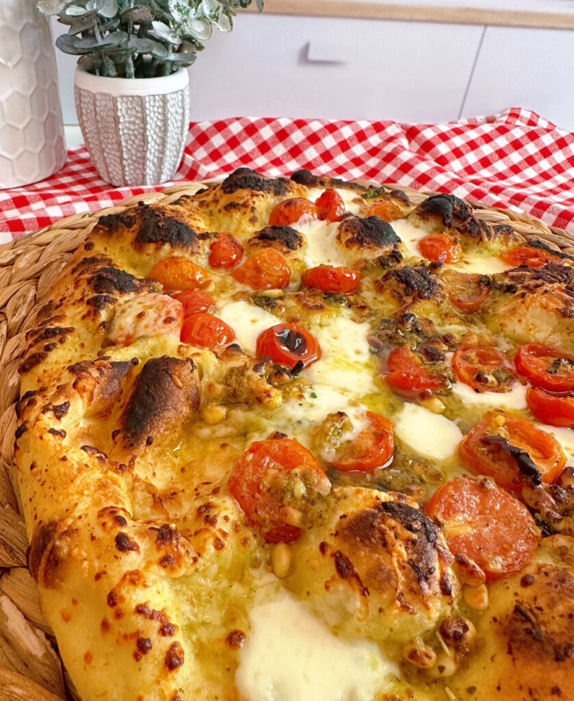 Photo of baked tomato and basil pizza.
