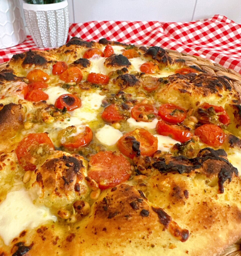 Basil Tomato Pizza on a table.
