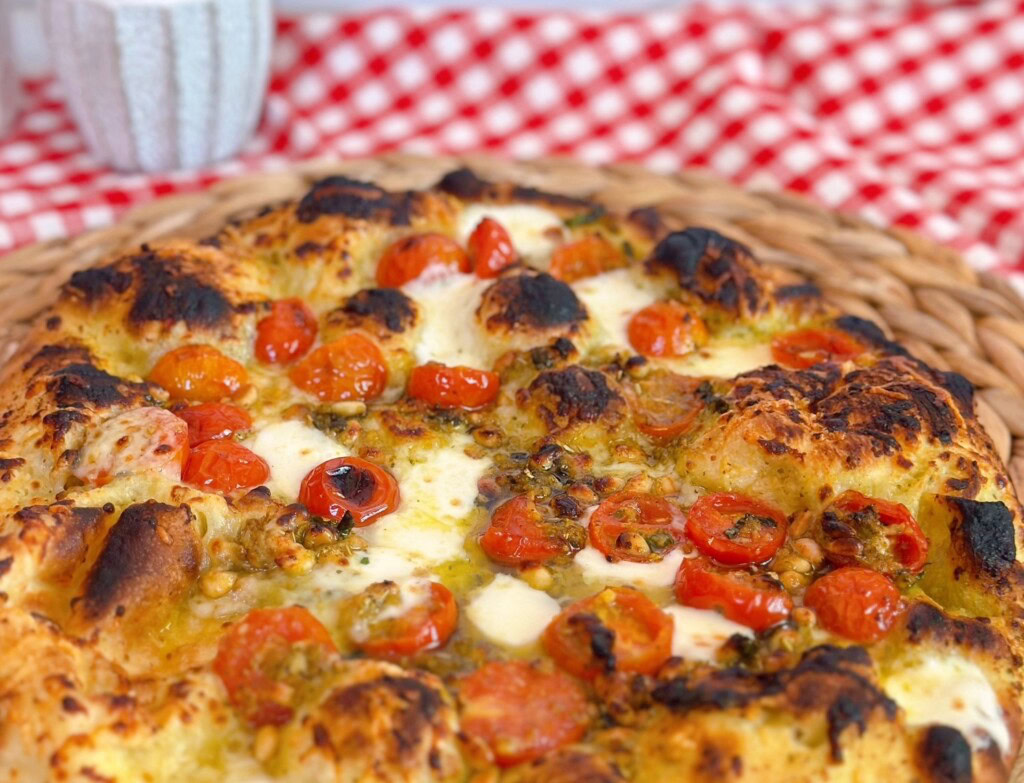 Tomato and Basil pizza baked with char on top.
