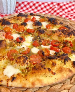 Up close photo of tomato basil pizza.