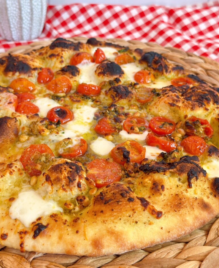 Up close photo of tomato basil pizza.