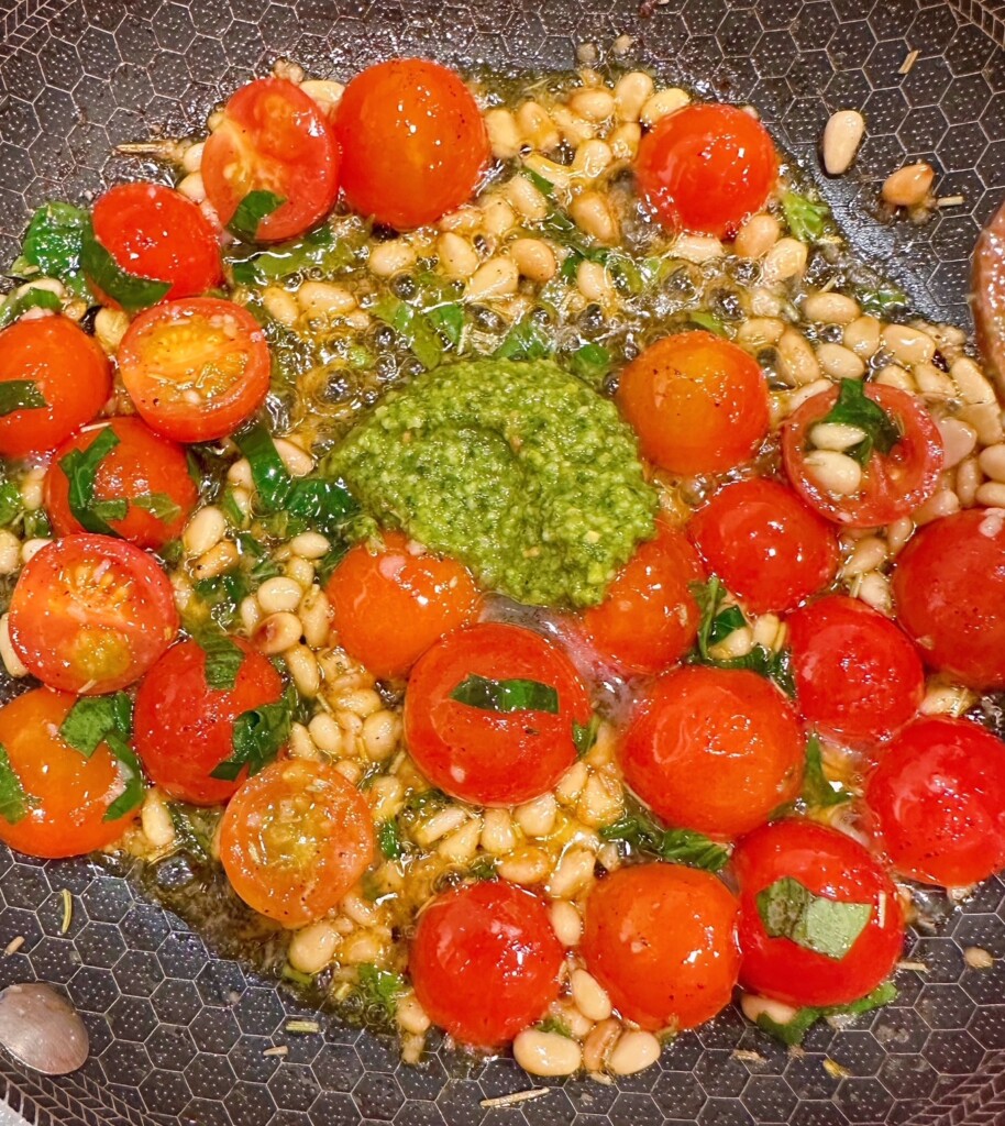 Add pesto sauce to tomato mixture.