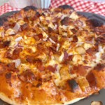Up close photo of Chicken BBQ Pizza with bacon.
