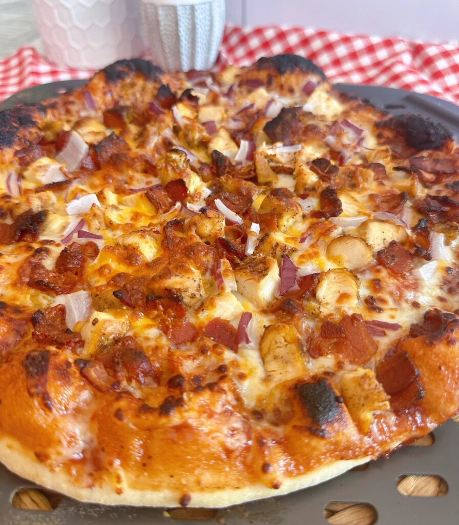 Up close photo of Chicken BBQ Pizza with bacon.