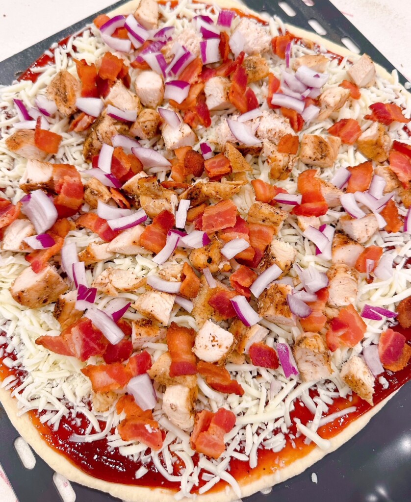 Pizza topped with red onion.