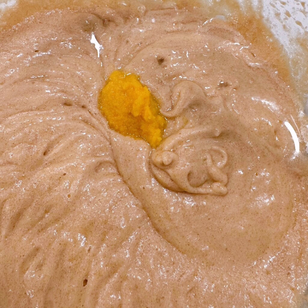 Adding Orange zest to cake batter.