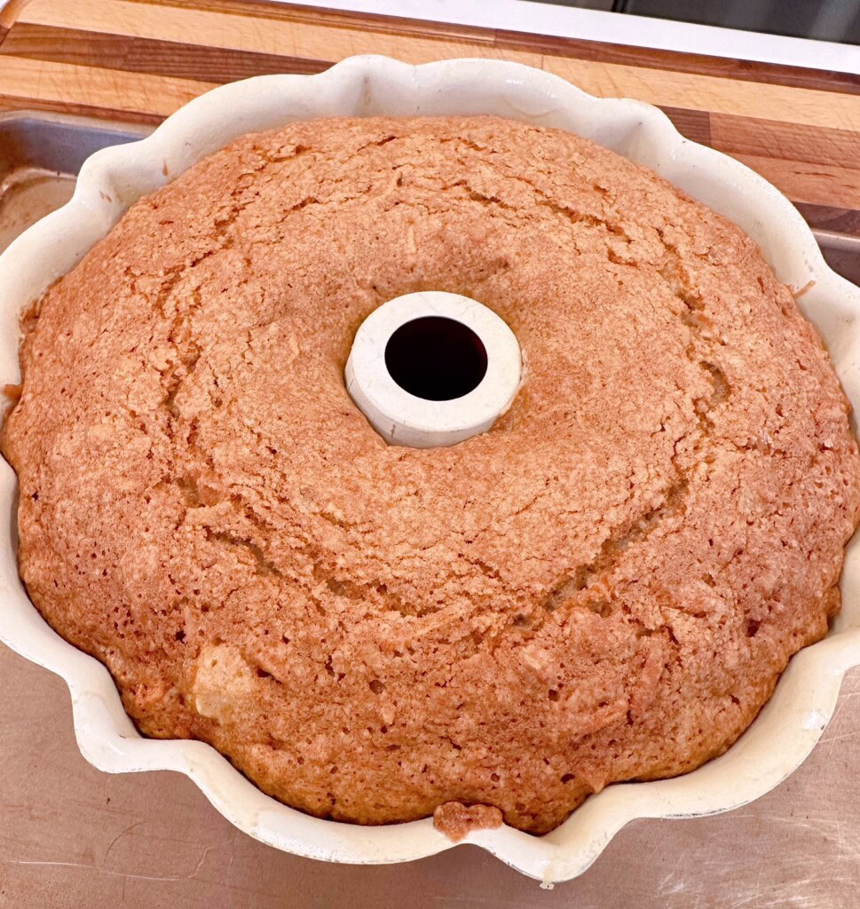 Baked apple cake in bundt pan cooling.