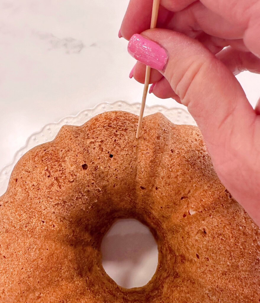 Poking holes in bundt cake.
