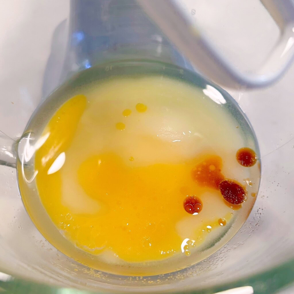 Adding "wet ingredients" in a mixing bowl.