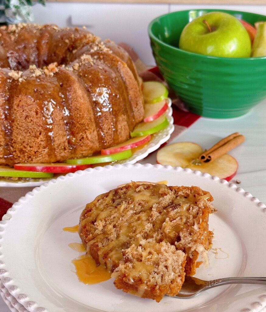 A piece of cake with a forkful ready to eat.