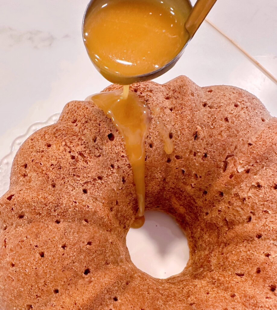 Drizzling Caramel Sauce over Cake.