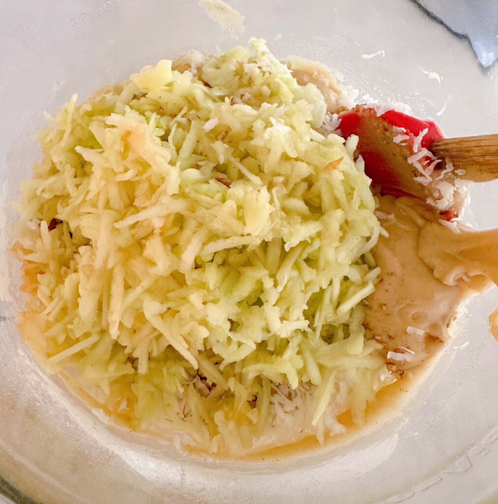 Folding in grated apples and coconut.