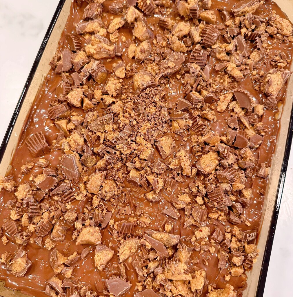 Peanut butter cups on top of rice krispie bars.