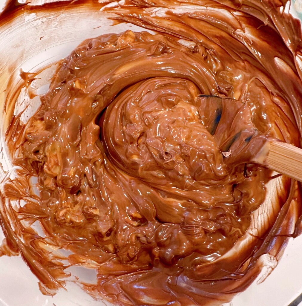 Chocolate and butterscotch chips melting in bowl.