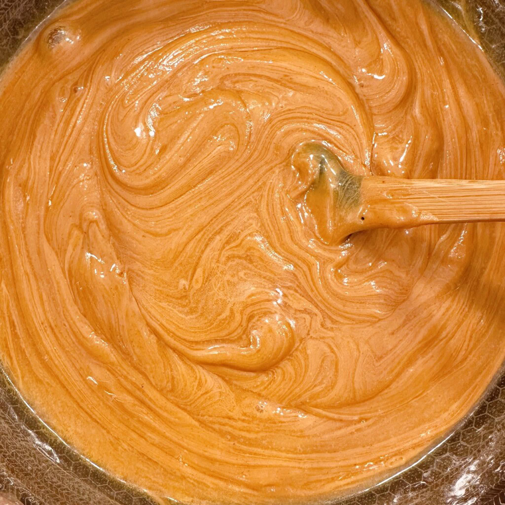 Stirring peanut butter into sugar mixture.